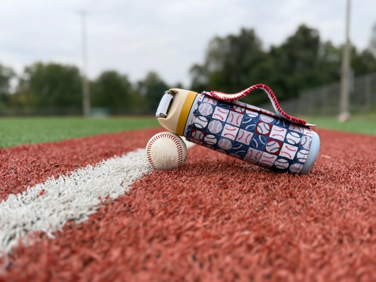 A water bottle leaning on a baseball